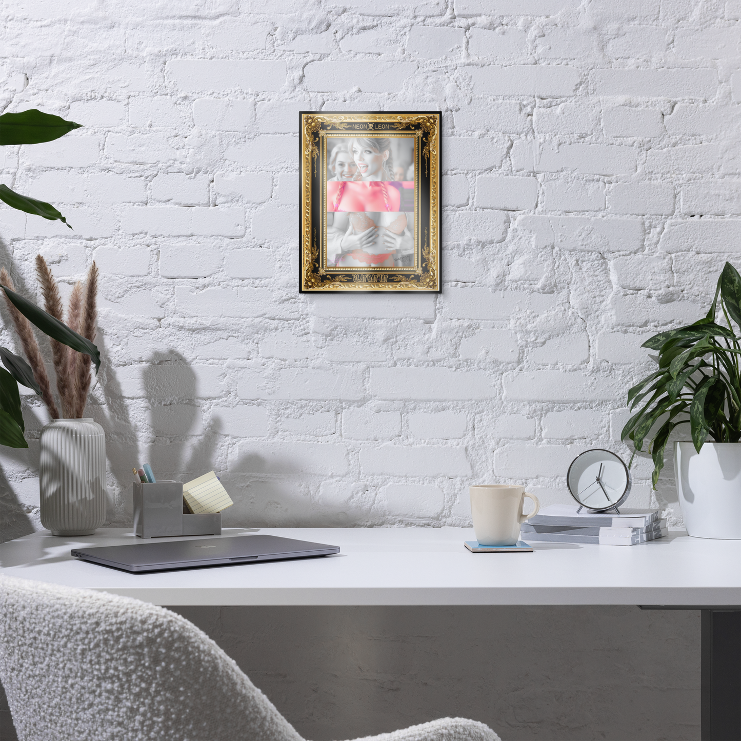 Home office with a white brick wall, desk, chair, and Collage of a woman, PlayDayTay, with a gold and black ornate frame, featuring the AiRt artist 'Neon Leon' .