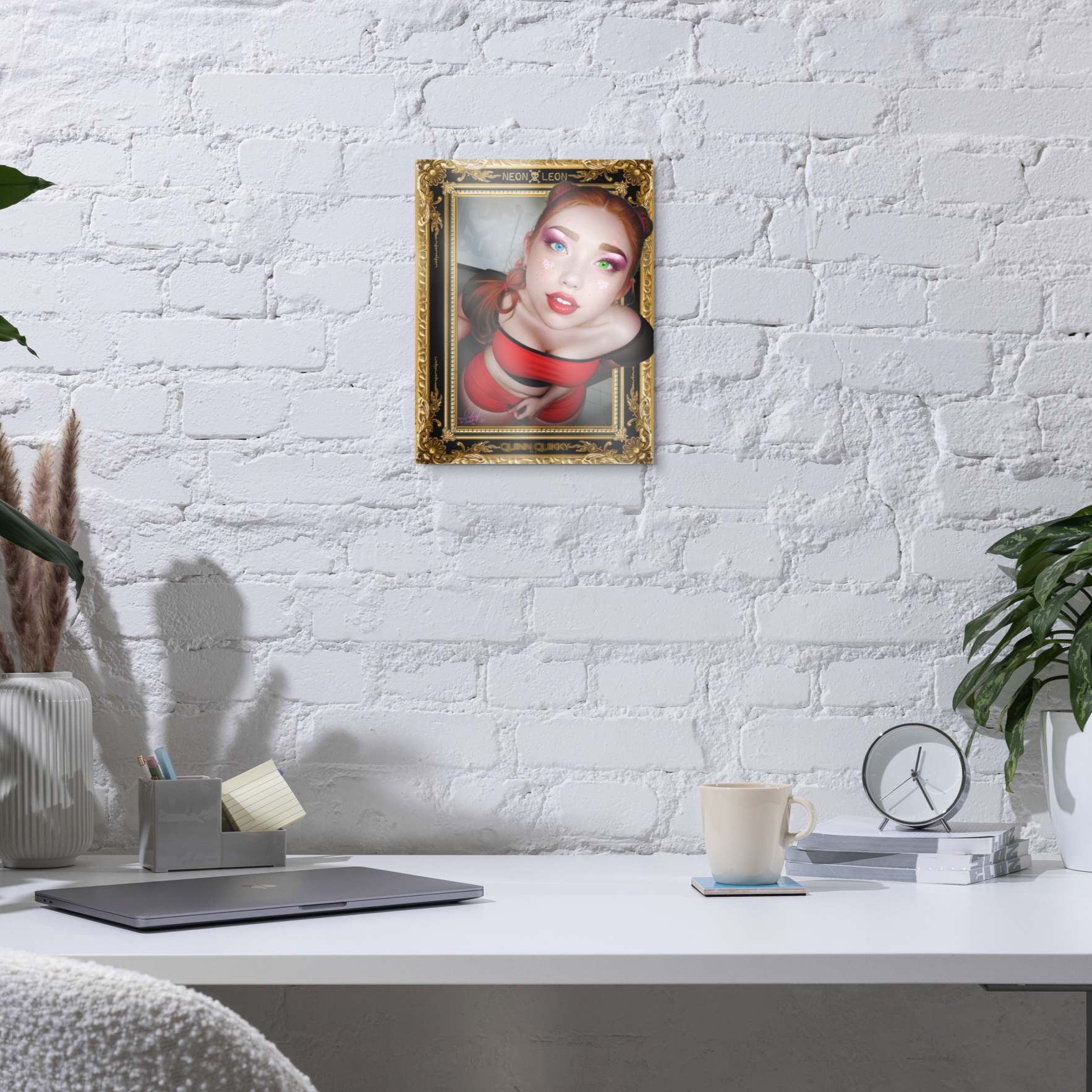 Framed portrait on a white brick wall above a desk with office items.